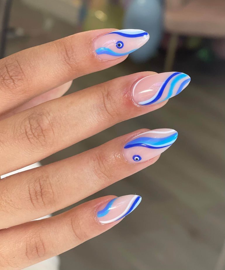 Blue and white swirl gel nails with eye detail by Corrine Jackson