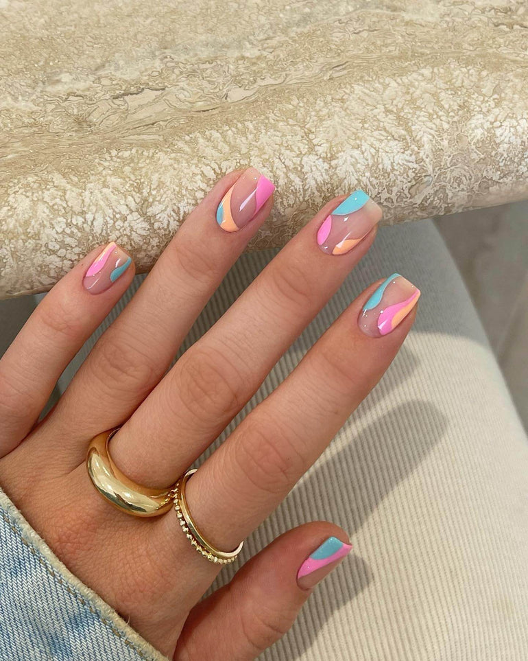 Gel nail art with pastel blue, pink and orange swirl detail by Joely Frain