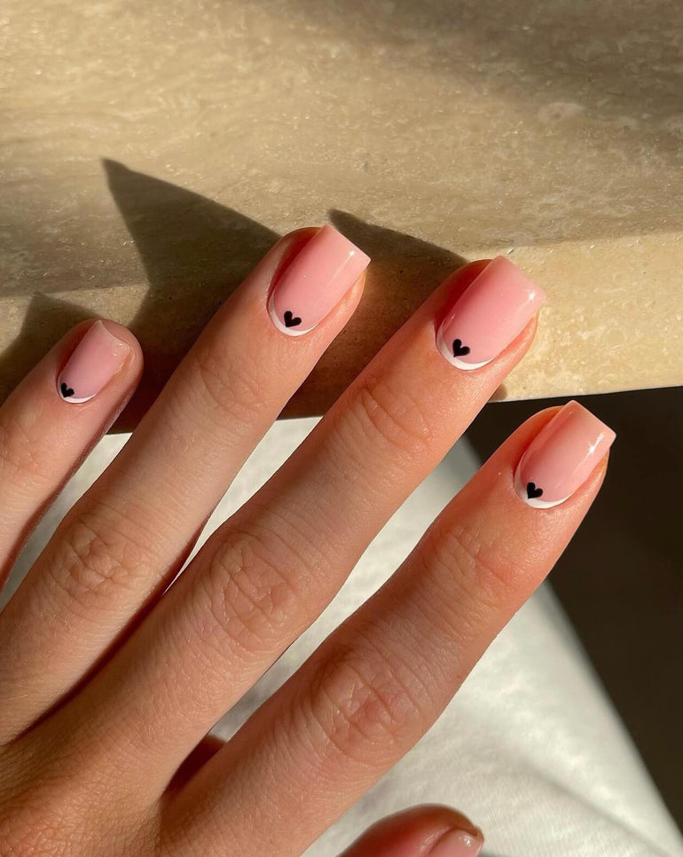 White cuticle gel nail art with black heart by Joely Frain