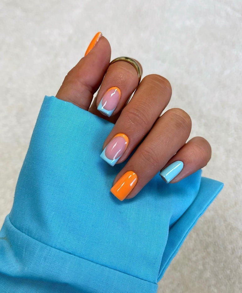 Alternating gel nail colours in bright blue and orange by Joely Frain