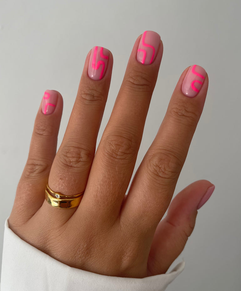 Muted pink gel nails with fluorescent abstract detail