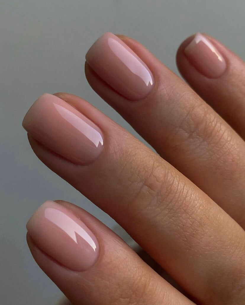 Nude gel nails by Hollie Barker against mid gray background