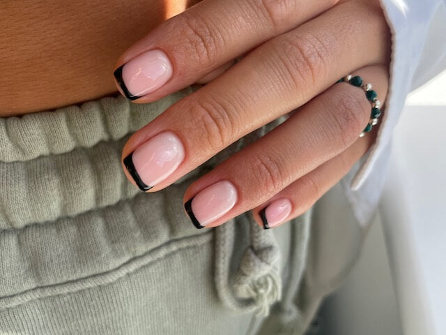 Nude gel polish with black tips by Chloe Boyce