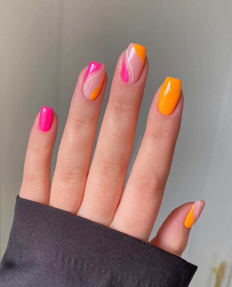 Bright pink and orange alternating nails with minimal white detail by Hollie Barker