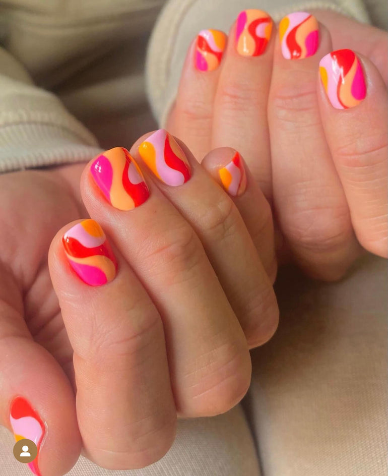 Retro swirl nail art in orange and pink by Ellie O'Hara