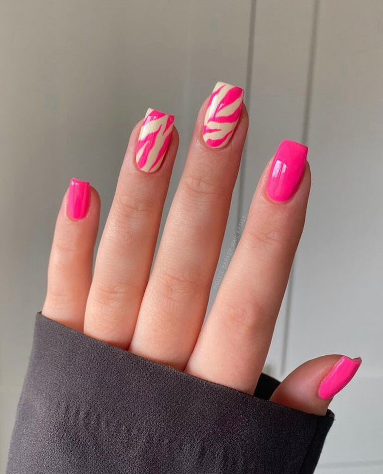 Bright pink and muted custard animal print gel nails by Hollie Barker