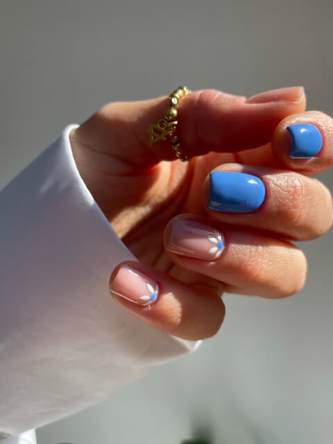 Blue and nude gel polish with flower detail by Chloe Boyce