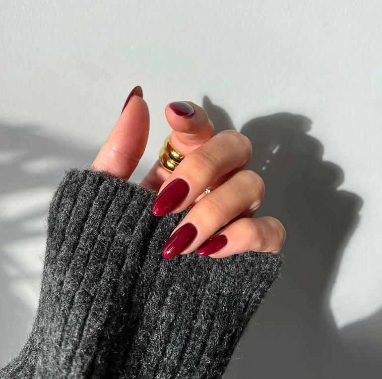 Deep glossy red gel nails by Naomi Brown
